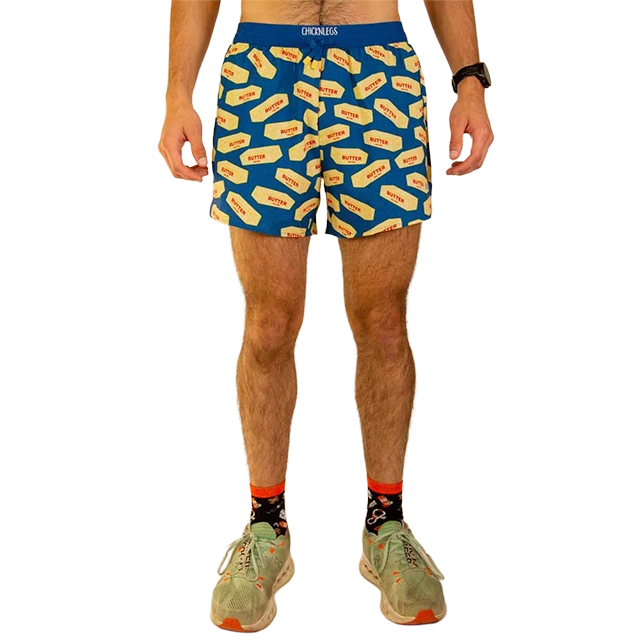 Person wearing blue shorts with hot dog prints and sneakers.