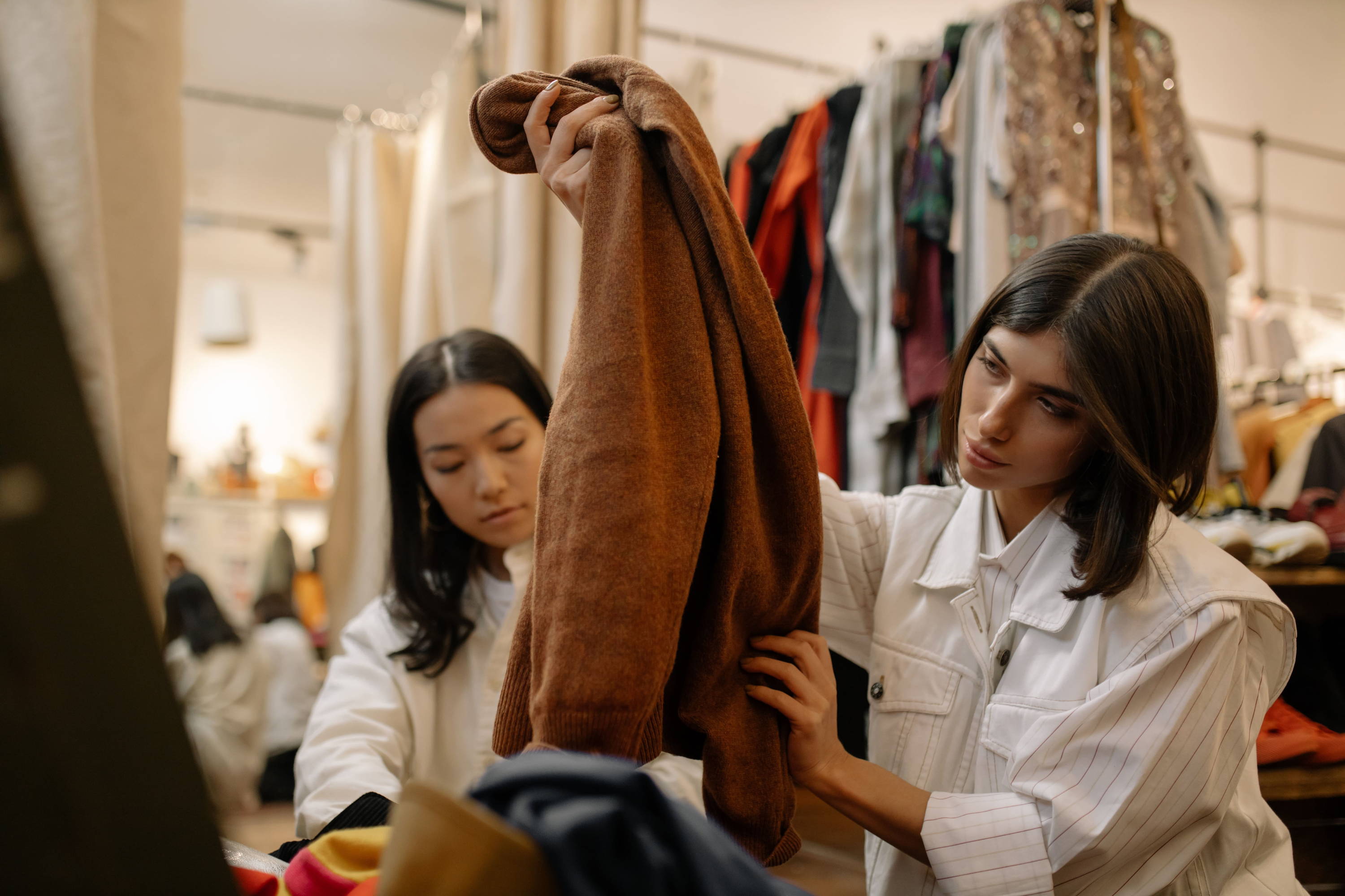 woman looking through vintage clothe