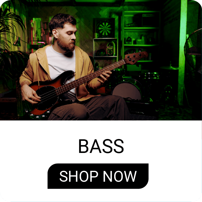 Man playing bass guitar in a music studio setting.
