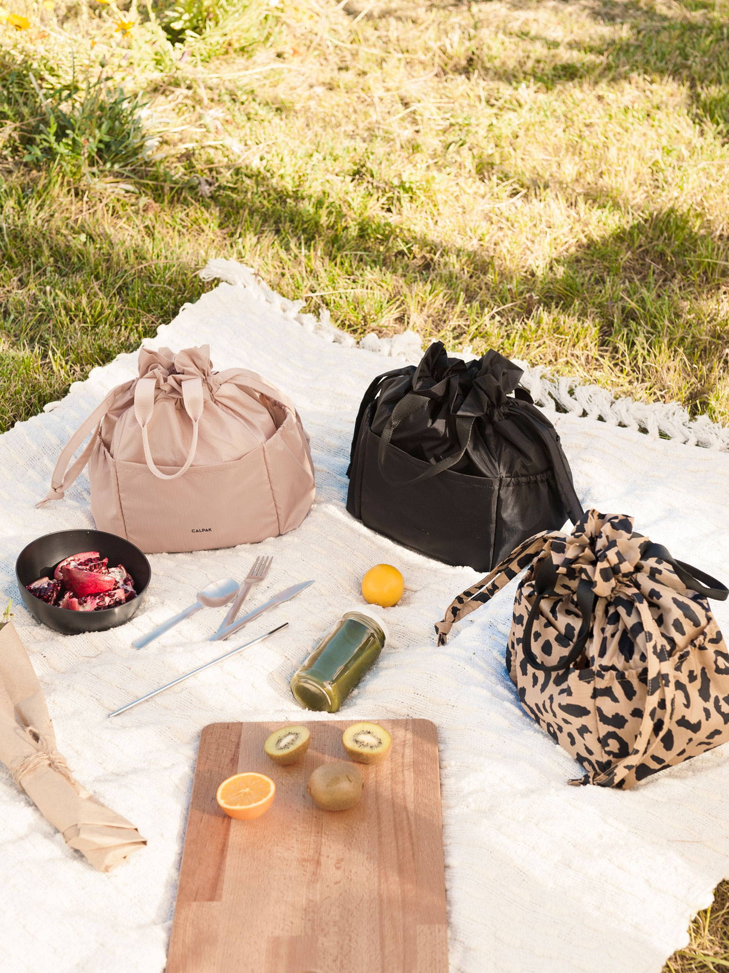 Group shot of all three Insulated Lunch Bags in Mauve, Black, and Cheetah