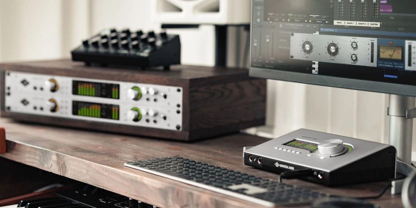 Audio equipment setup with rack-mounted processors and a computer monitor.