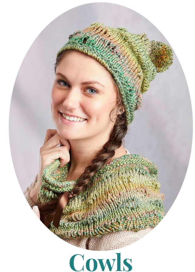 Smiling woman wearing a knitted hat and cowl in green tones.