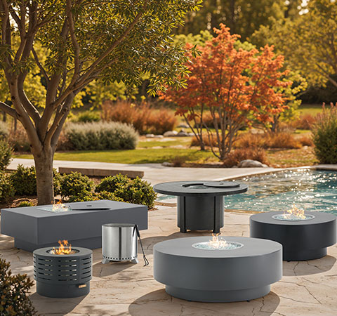 Outdoor seating area with modern furniture near a pool and trees.