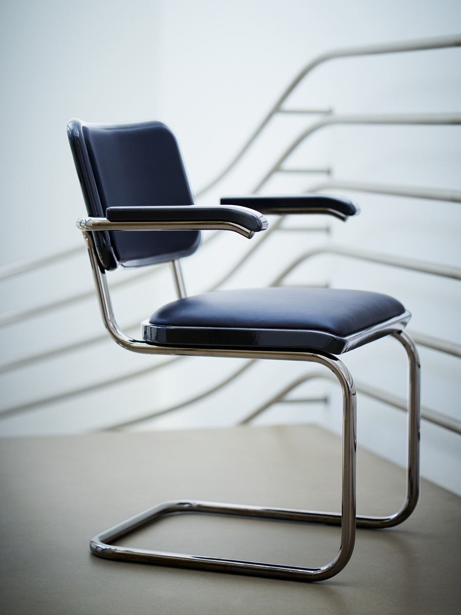 A modern chair with a sleek design and metal frame.