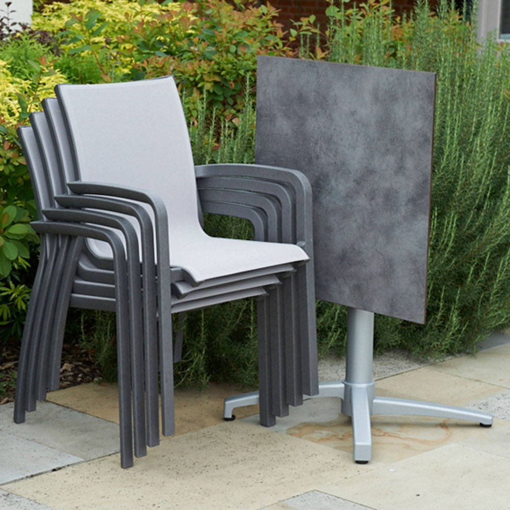 Modern grey stacking armchairs on a patio.