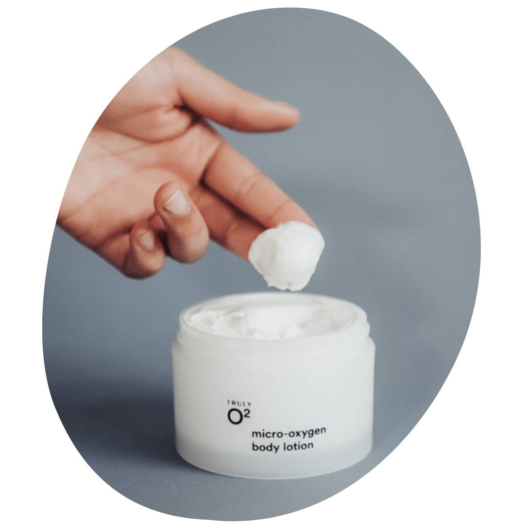 A person dips their fingers into Truly O2 oxygen skincare