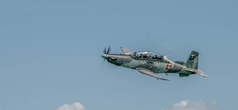 A Mexican Hawker Beechcraft T-6C+ Texan II aircraft patrols the bay for enemy vessels during exercise Tradewinds 2022 (TW22), at Chetumal Bay, Mexico, May 15, 2022. TW22 is a U.S. Southern Command-sponsored Caribbean-focused multi-dimensional exercise conducted in the ground, air, sea, and cyber domains, designed to provide participating nations opportunities to conduct joint, combined, and interagency training focused on increasing regional cooperation and interoperability in complex multinational security operations. (U.S. Marine Corps photo by Sgt. Matthew Teutsch)