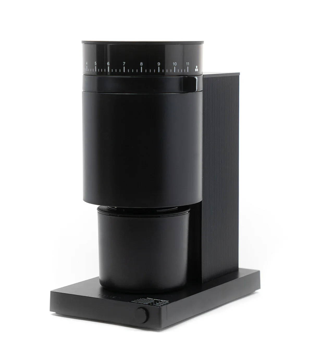 A black coffee maker with a cup positioned underneath.