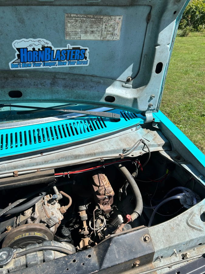 Open hood HornBlasters sticker solenoid clear tubing rusted master cylinder teal engine bay Blake's Econoline Dixie gallery photo 3