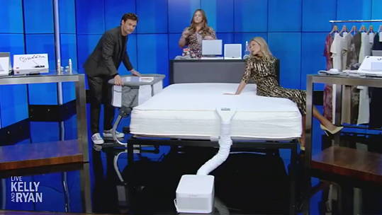 A still from the show Live with Kelly and Ryan, showing the hosts discussing BedJet