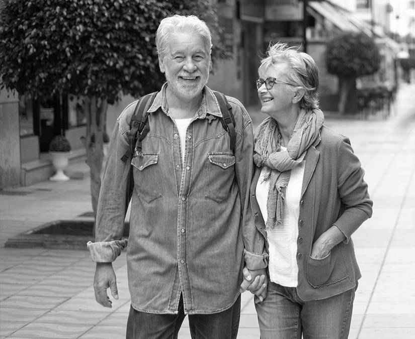 Older couple walking together hand in hand 