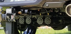Five train horns and B&W trailer hitch mounted on the rear undercarriage of Ryan's Dodge Ram 1500