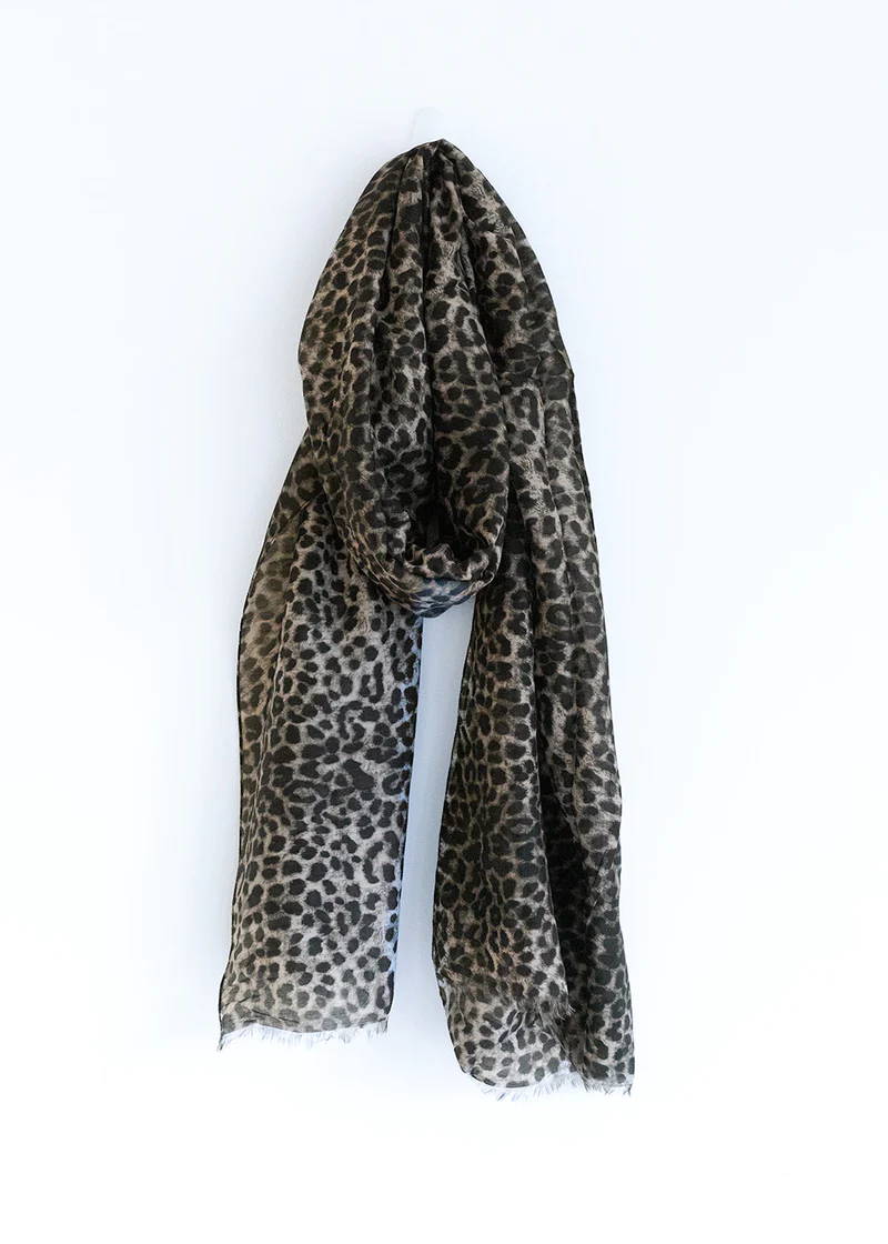 A grey and black leopard print silk mix scarf with reaw hem detailing