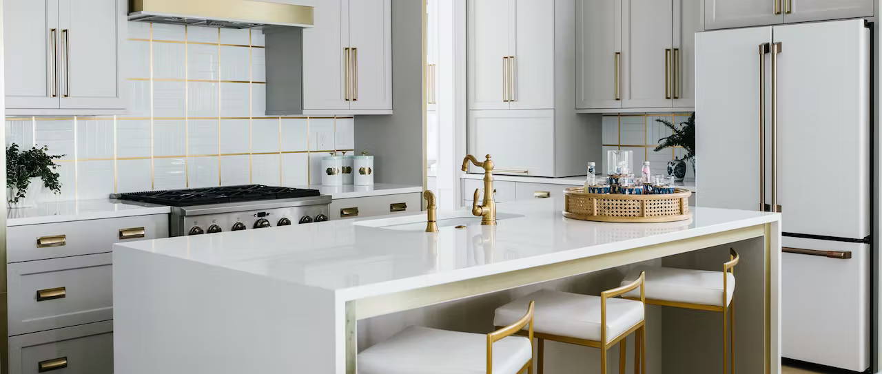 Matte white appliances in white kitchen with metal accents