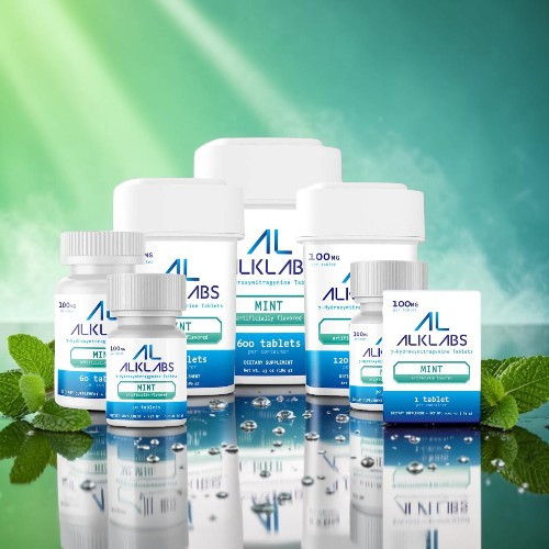 Assorted health supplement bottles on a reflective surface with green background.