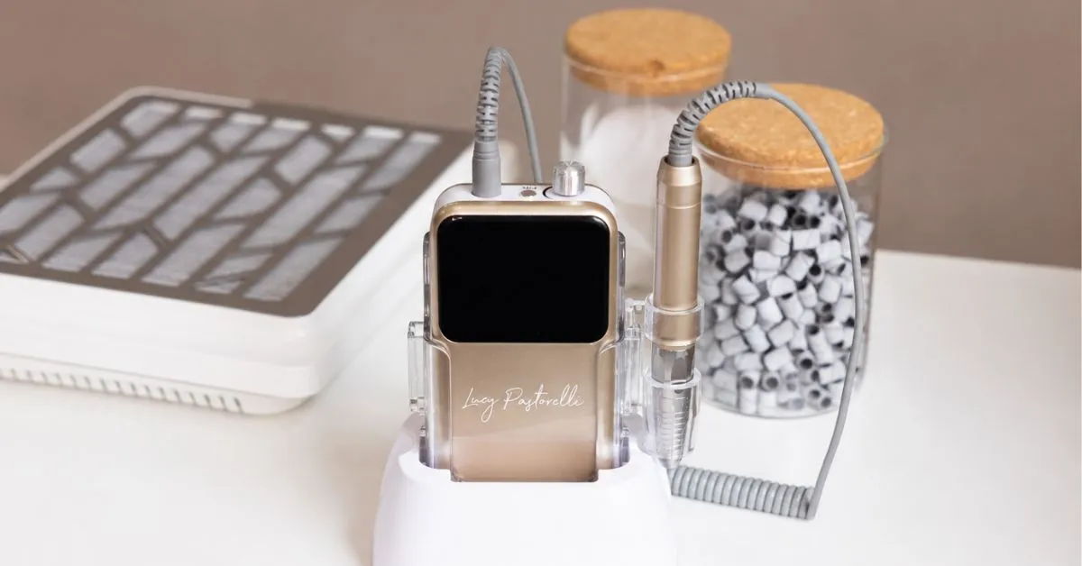 Lucy Pastorelli champagne e-file on a nail desk.