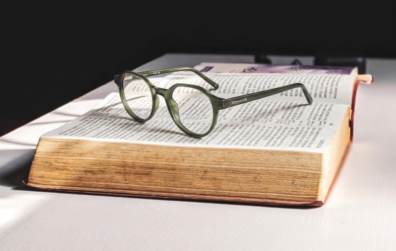 Wonder green glasses on an open chunky old book