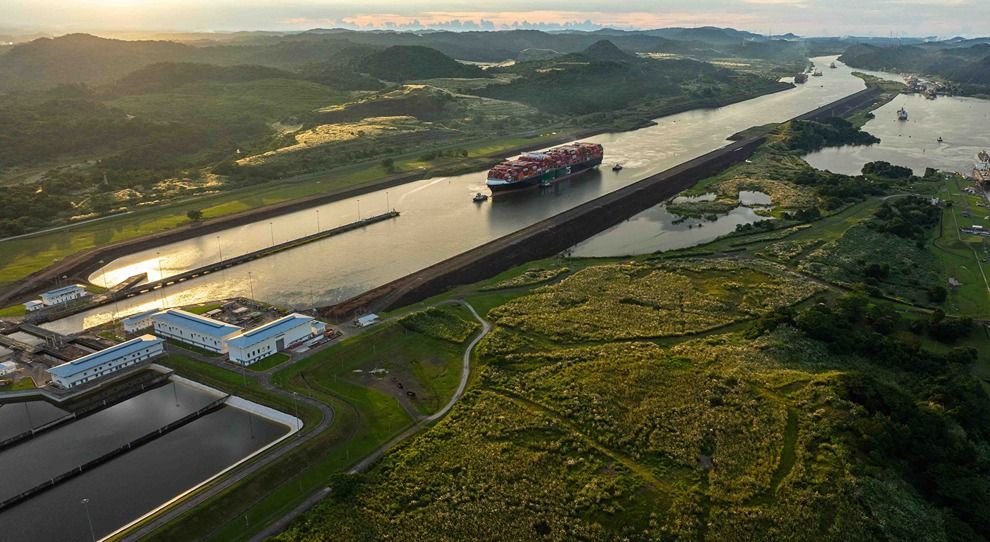 Aerial view of the Panama canal with a container ship moving through its locks..