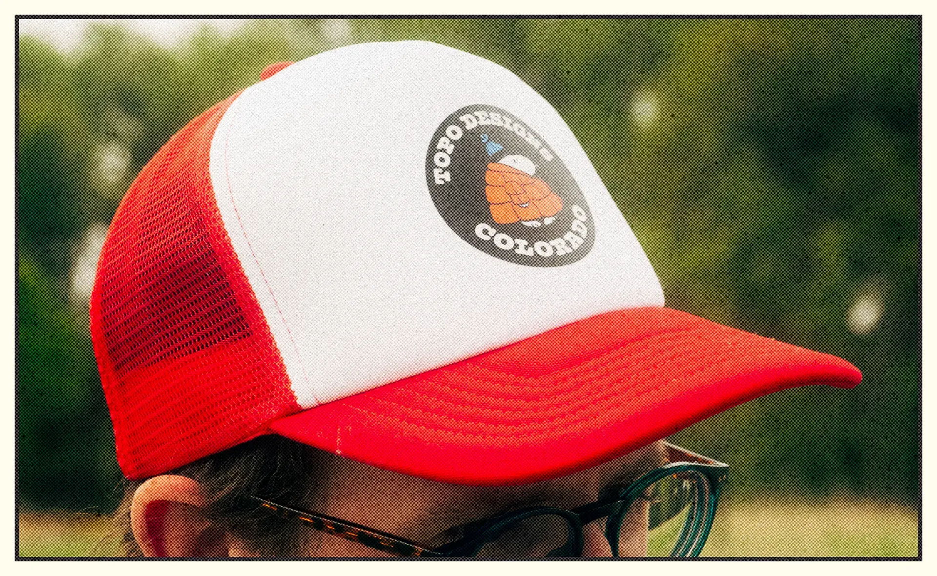 A red and white cap with a logo on the front.