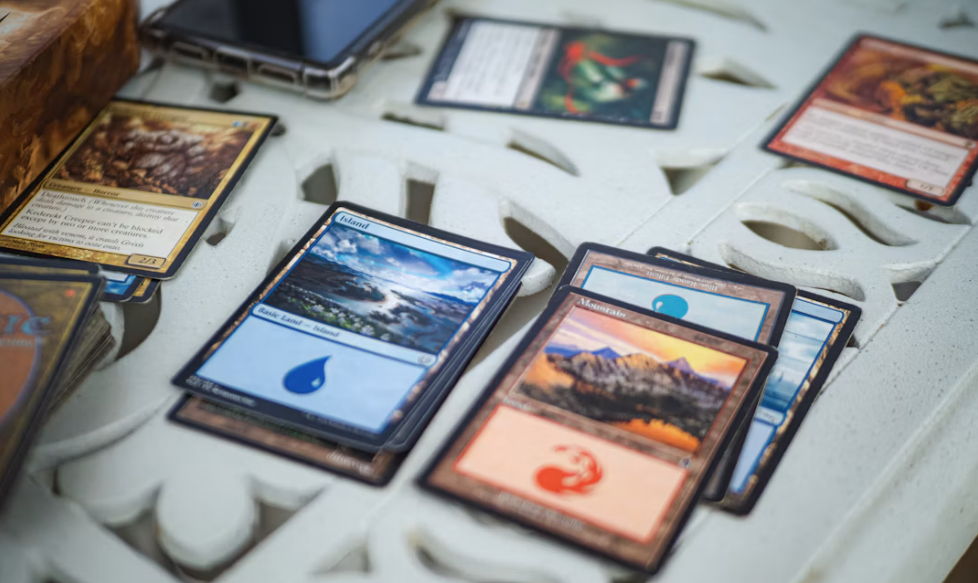 how to play magic the gathering commander - A collection of trading cards on a decorative table.