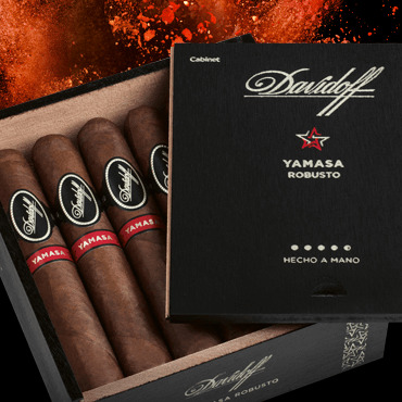 Davidoff Yamasa cigars in their box with the lid open. Red earth in the background.
