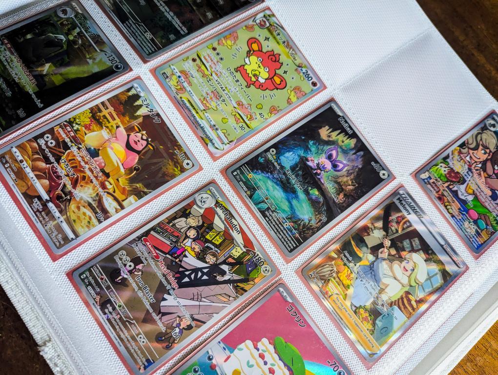 Collection of trading cards displayed in a binder.