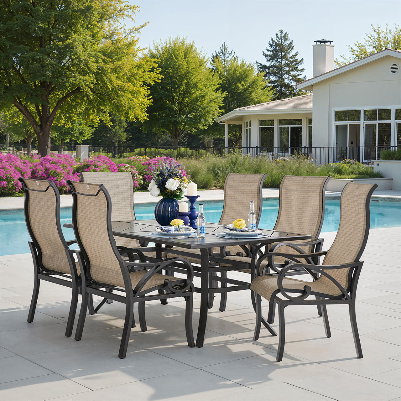 Outdoor dining set by a pool with chairs and a table.