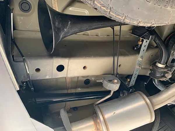 Black train horn trumpet mounted under Carrie's Acura MDX near rear exhaust and spare tire photo 3