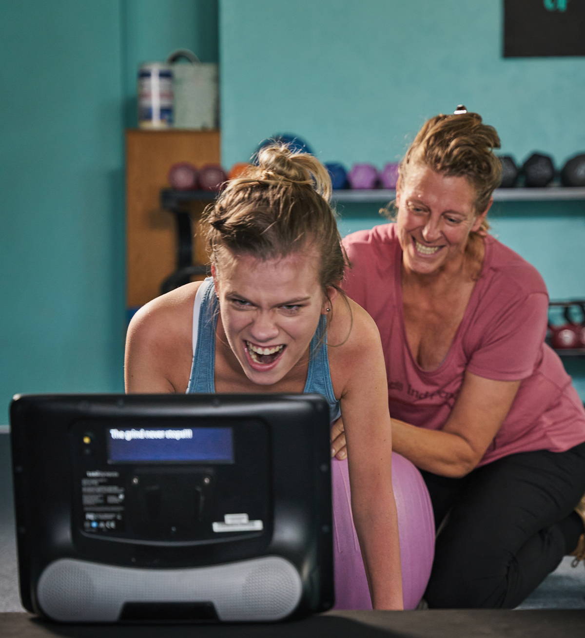 young woman using an AAC device while working out
