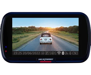 Dashboard camera displaying a car driving on a scenic road at sunset.