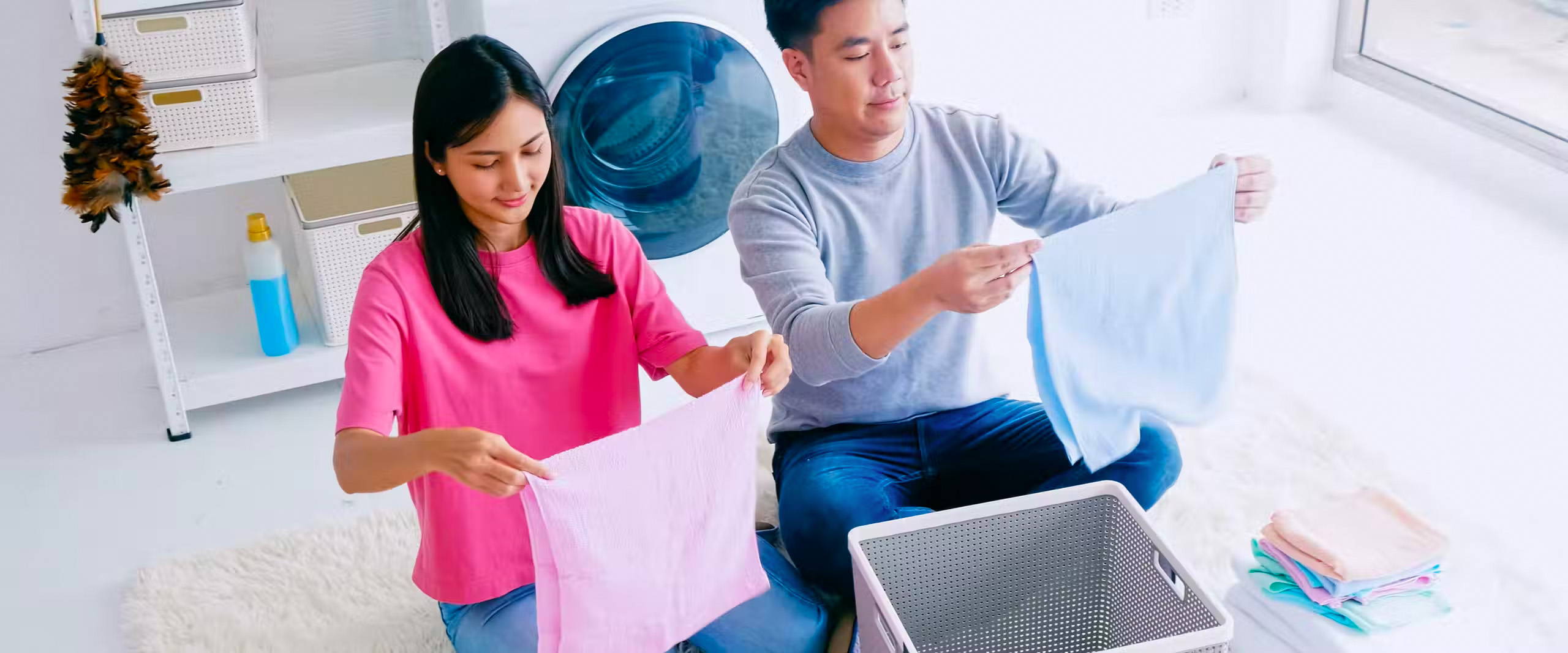 Woman and man folding laundry