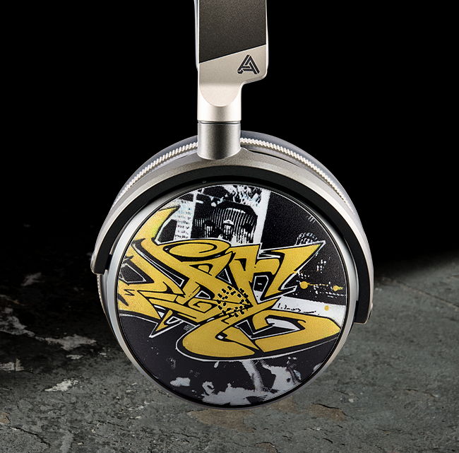 Headphone with graffiti-style artwork and a silver design.