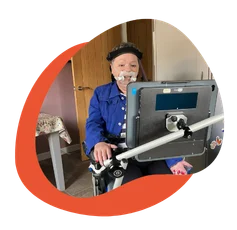 Elderly person using a communication device in a home setting.