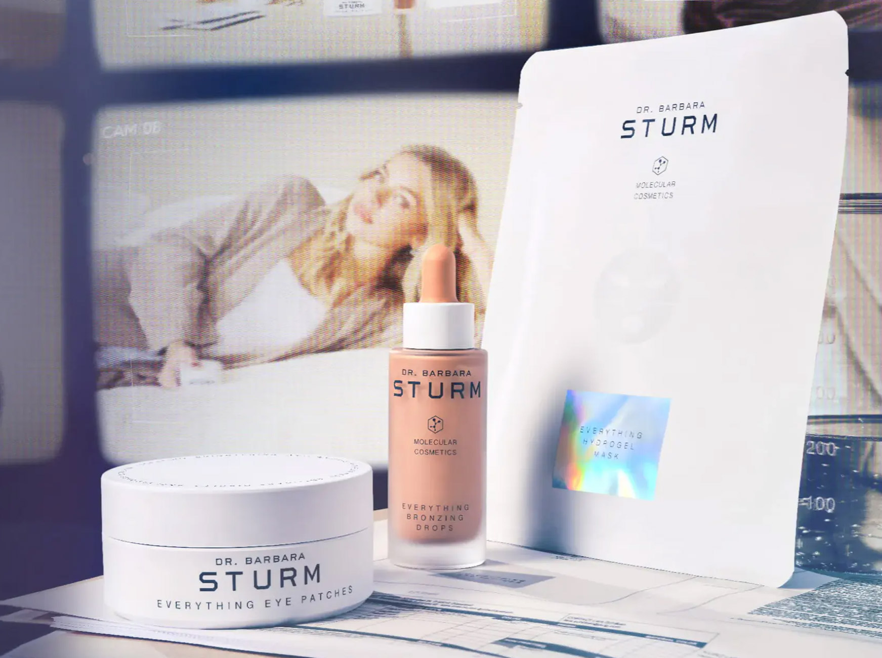 Skincare products displayed with a model in the background.
