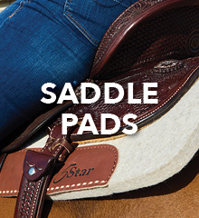 A close-up of a saddle pad with jeans and saddle details.
