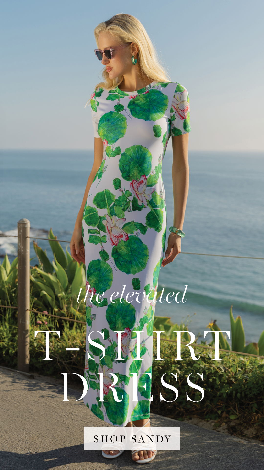 Model in a floral dress by the ocean, promoting a t-shirt dress.