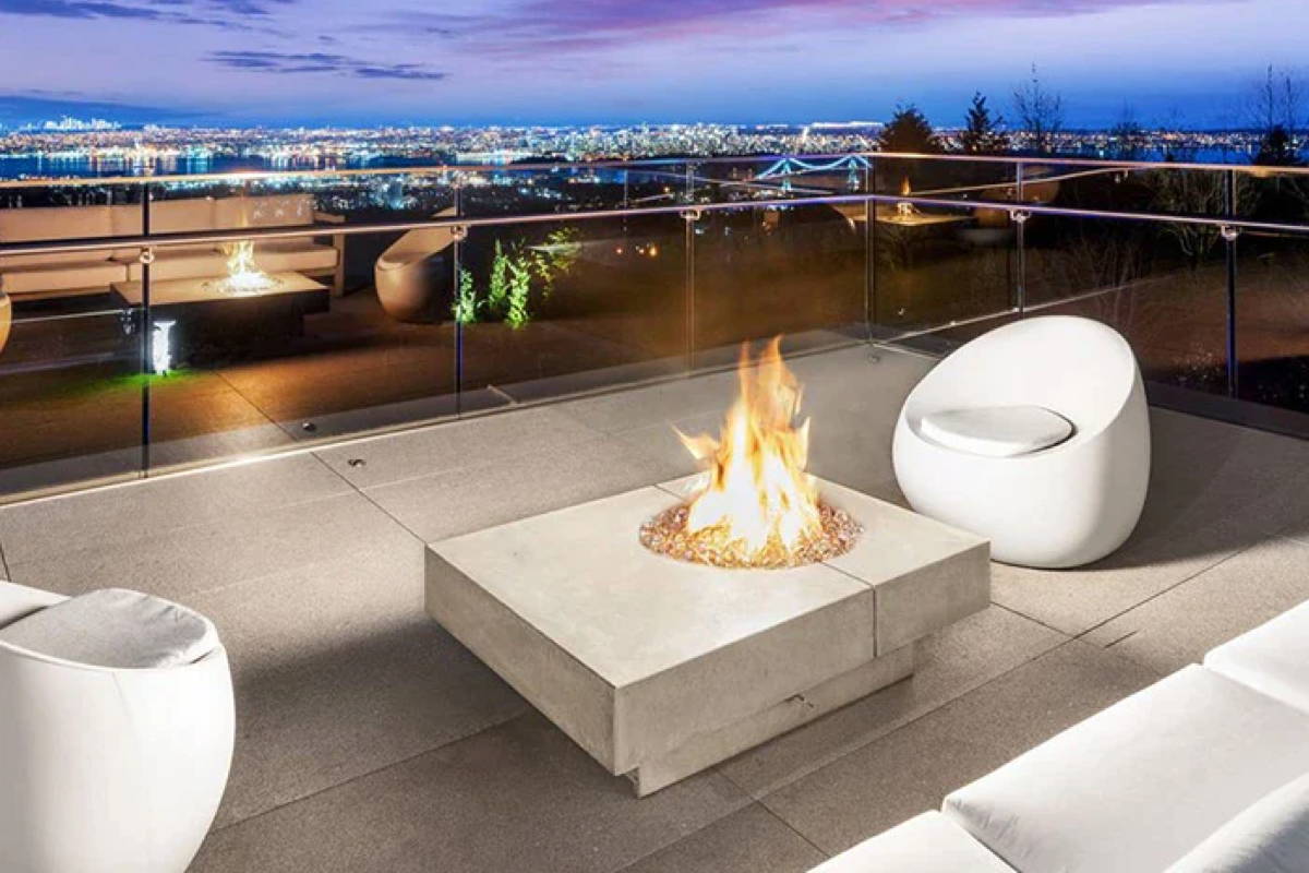Outdoor patio with white furniture and a concrete fire pit.