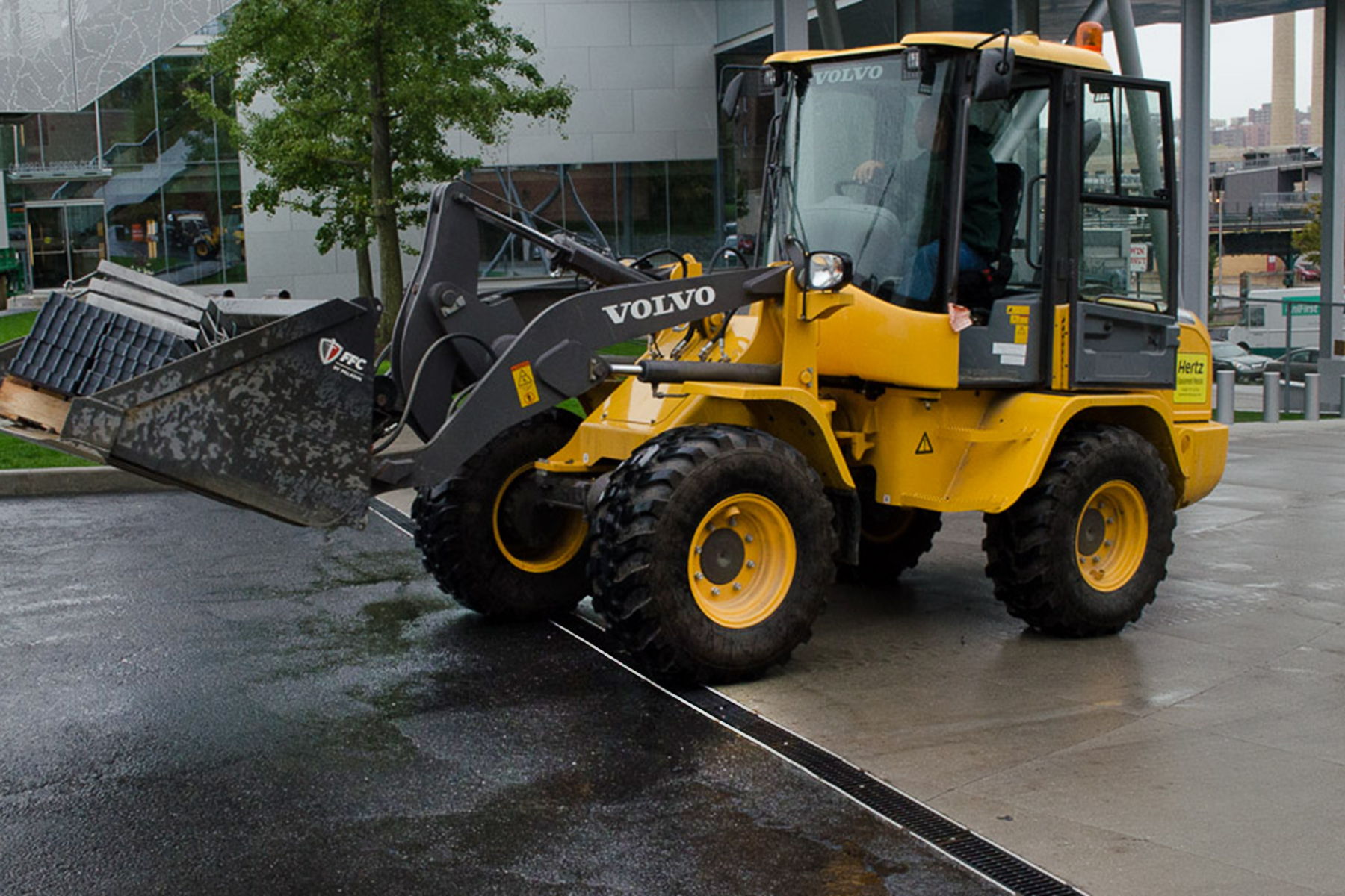 Transportation - heavy-duty grates - large tractor moving over grating in parking lot