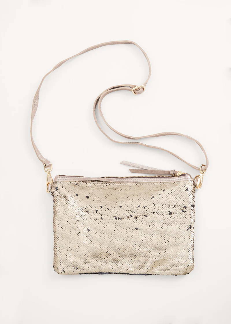 A gold clutch bag with reversible sequins and detachable shoulder strap