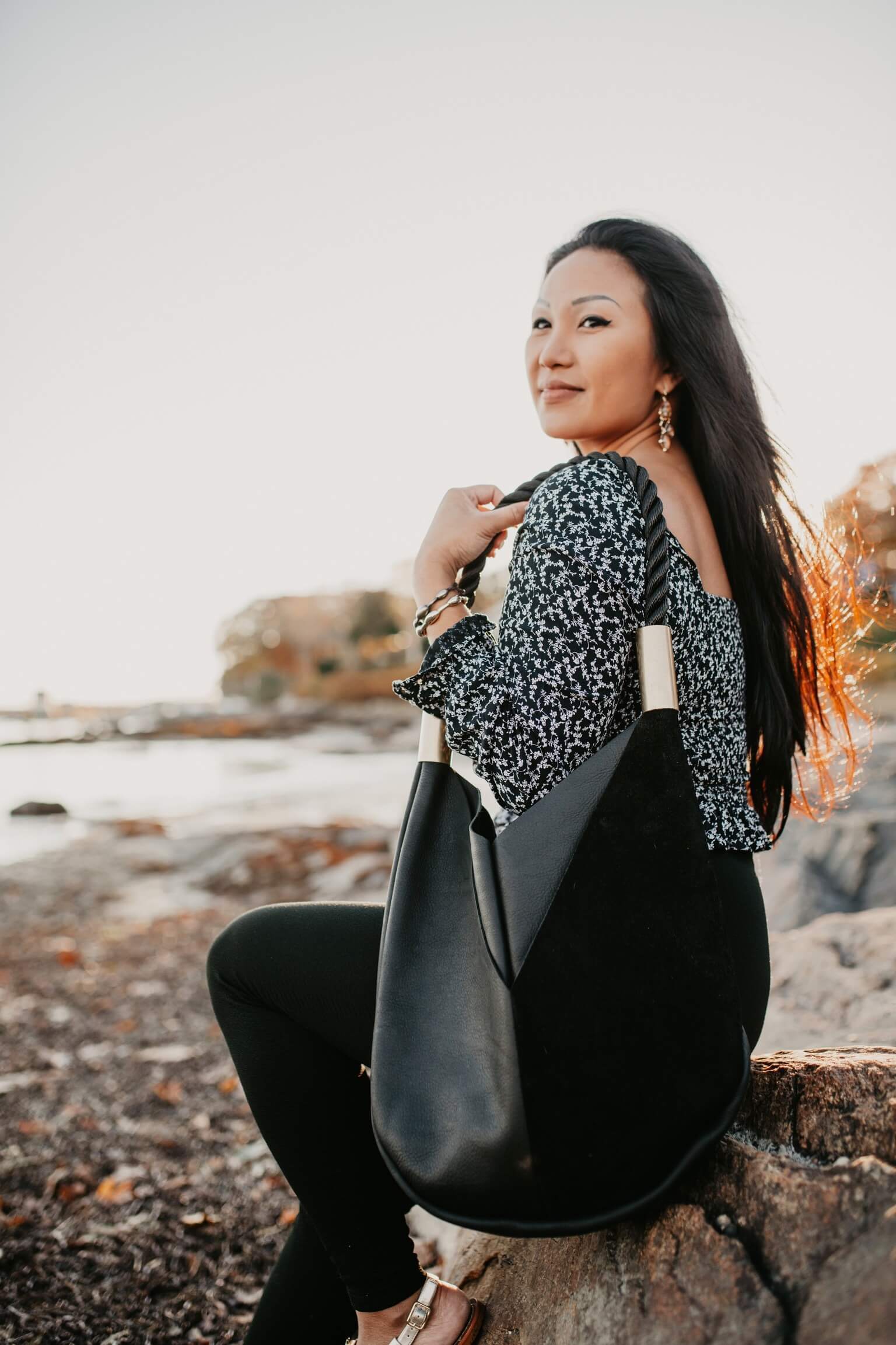 woman wearing black leather tote bag