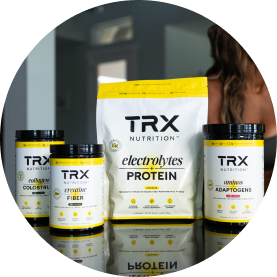 TRX Nutrition products displayed on a reflective surface.