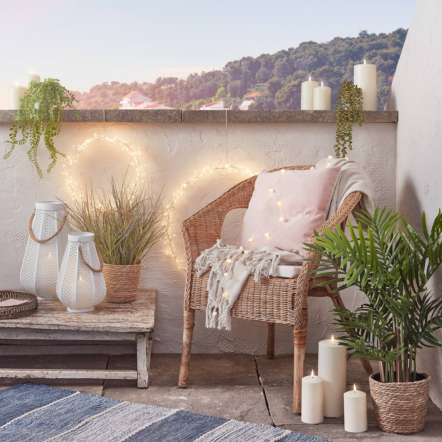 An outdoor haven at home with starburst lights, candles & lanterns