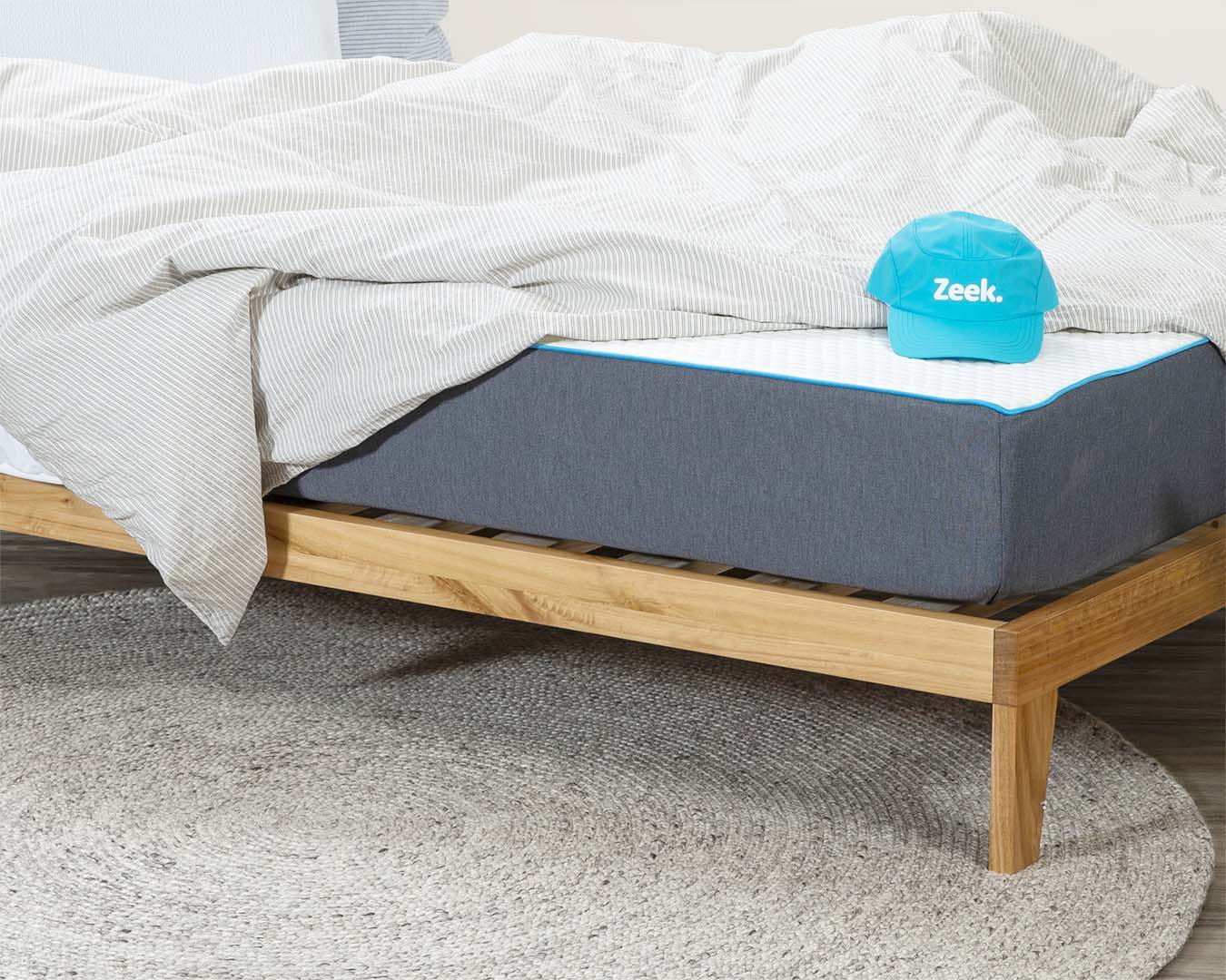 A Zeek model lounging about on a Zeek bed and mattress.