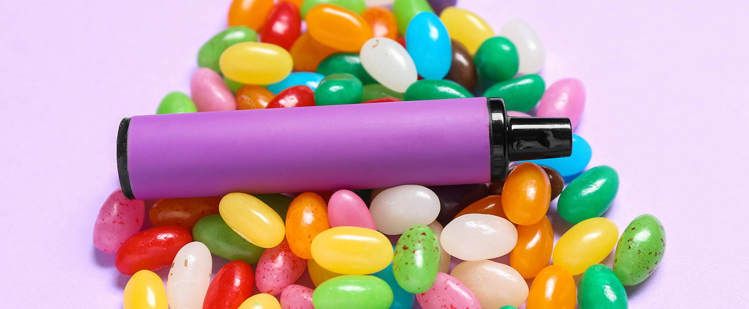 Photo of a disposable vape and candy