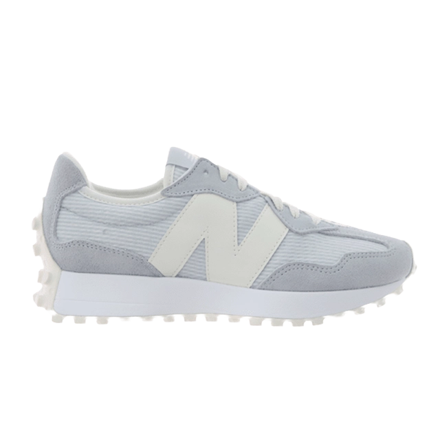 Gray and white New Balance sneakers, side view, with textured materials.