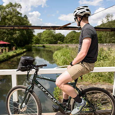 A mountain bike featuring a front electric conversion kit.