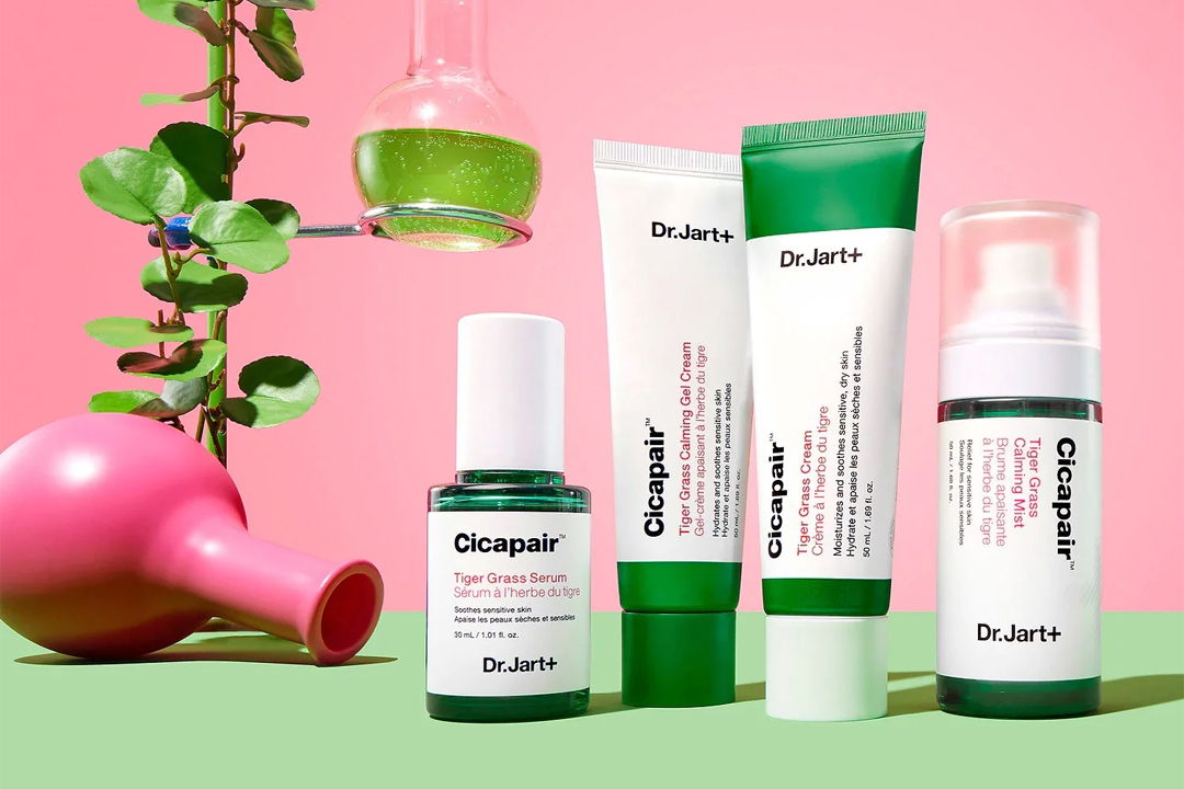 Skincare products displayed with a pink background and green accents.