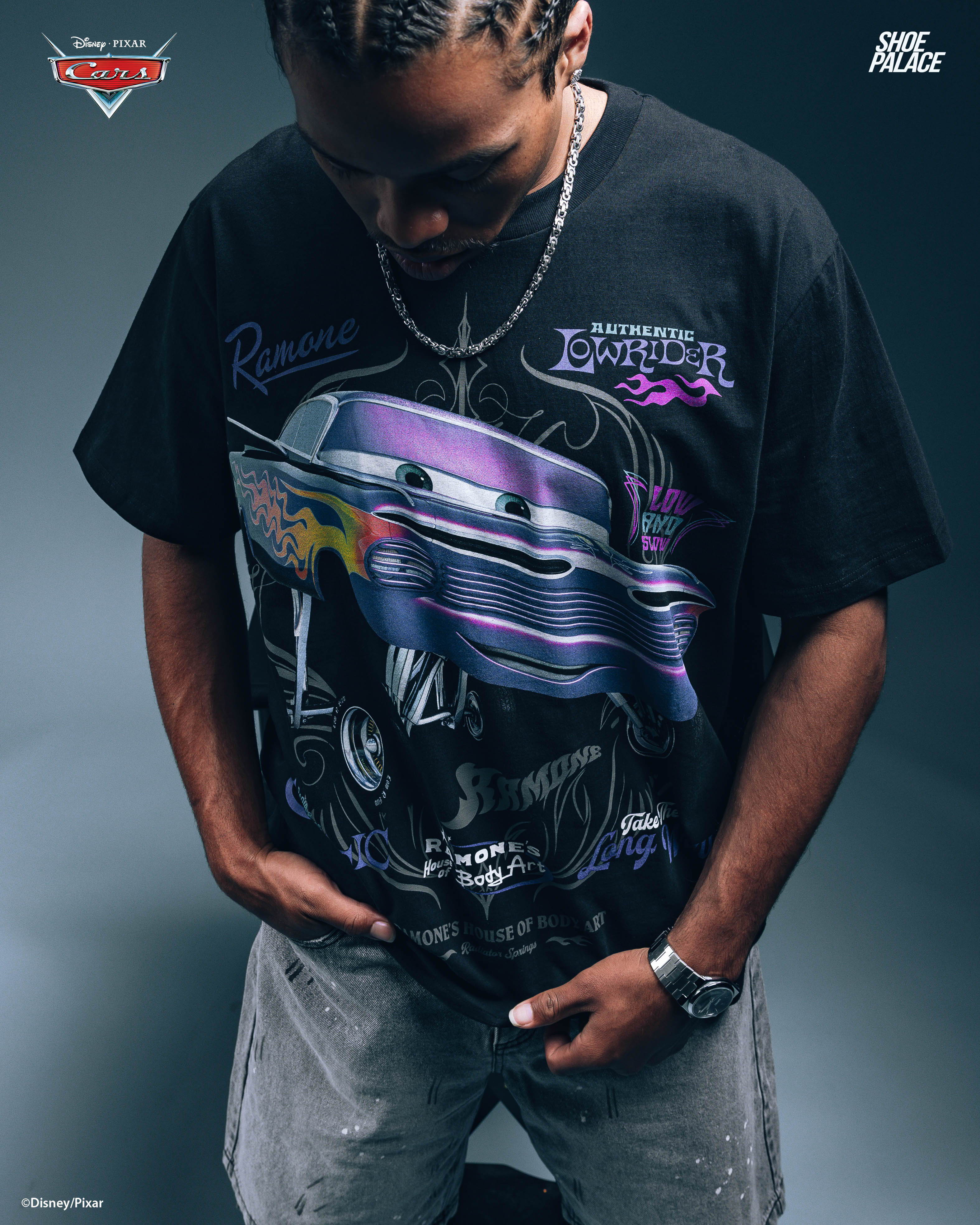 Person wearing a graphic t-shirt with a colorful car design.