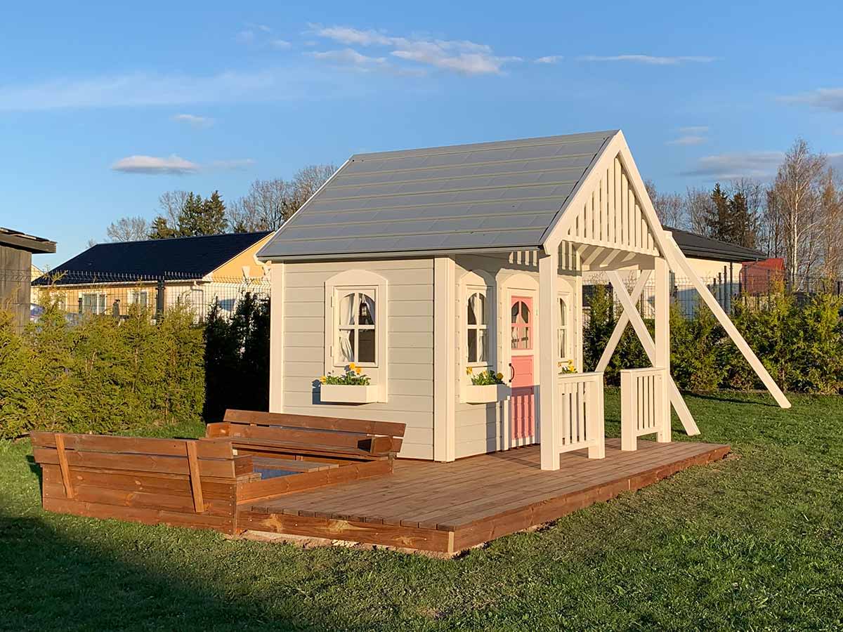 Wooden Custom Playhouse with wooden terrace with and white railing in the backyard by WholeWoodPlayhouses 
