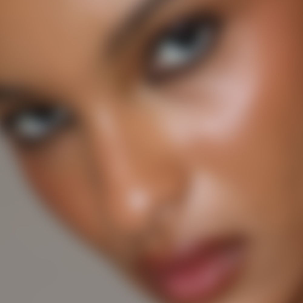 Blurry close-up of a person's face with intense eyes.